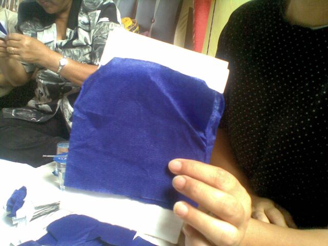 TARUH DUA LEMBAR KERTAS KREPE DI ATAS DUA LEMBAR KERTAS PHOLIO BEKAS. 